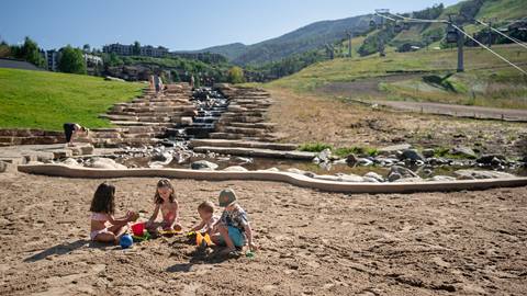 Four children playing at the Burgess Creek Beach at Steamboat Resort.