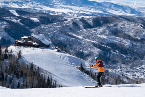 a man skiing overlooking Thunderhead Lodge  in the distance