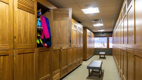 ski lockers with a sitting bench