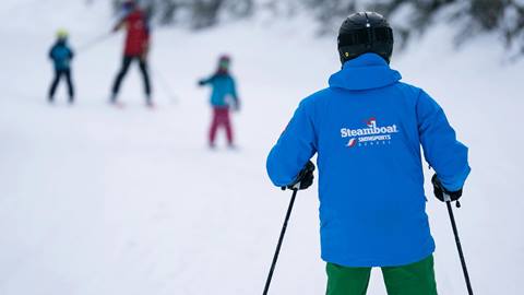 Diverse Instructor with Happy Camp Ski Students